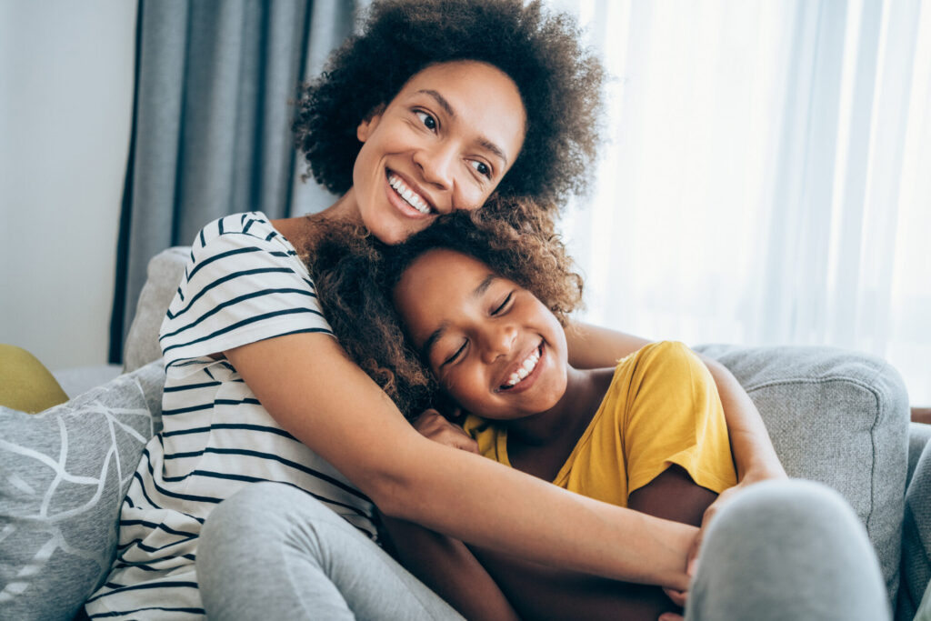Lovely mother embracing her cute daughter
