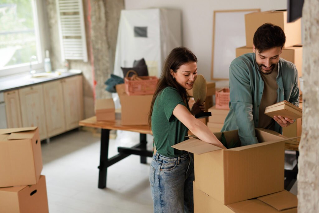 Happy young couple unpacking